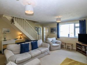 a living room with a couch and two chairs at Wingelock in Rhosneigr