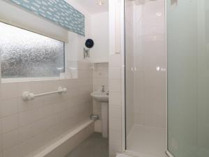 a bathroom with a shower and a sink at Wingelock in Rhosneigr +29 photos