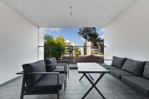 a living room with a couch and a table at Spacious Luxury Beach Getaway by Torohome in Ashdod