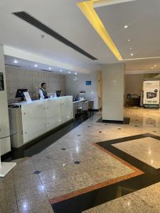 a man sitting at a desk in a lobby at Hotel Sol Alphaville in Barueri +13 photos