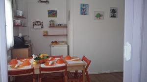 a dining room with a table and chairs with oranges on it at Le due magnolie in Cotignola