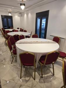 a row of tables and chairs in a room at Hotel Al Abraj in Oran