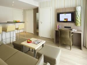 a living room with a couch and a table at ibis Styles Zeebrugge in Zeebrugge
