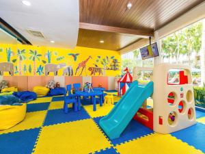 a play room with a slide and play equipment at Grand Mercure Phuket Patong in Patong Beach