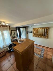 a kitchen with a wooden island in a room at Hostal Arévacos in Soria