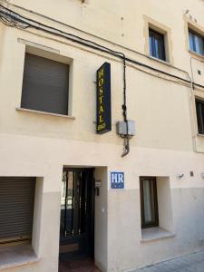 a building with a sign on the side of it at Hostal Arévacos in Soria