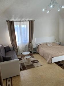 a bedroom with a bed and a couch at Sicilia Ambiente in Montedoro +7 photos