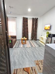 a living room with a couch and a table at Stylish Mtwapa Studio with Rooftop Pool View in Mtwapa