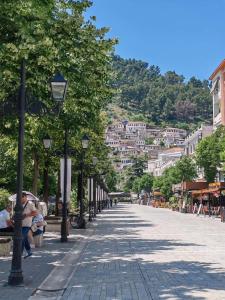 a city street with people sitting on a bench at Vangert Apartment in Berat