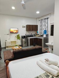 a room with a bed and a kitchen at Stylish Mtwapa Studio with Rooftop Pool View in Mtwapa