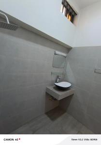 a bathroom with a sink and a mirror on the wall at Résidence saint Daniel in Cotonou +23 photos