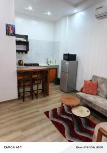 a living room with a couch and a table and a kitchen at Résidence saint Daniel in Cotonou