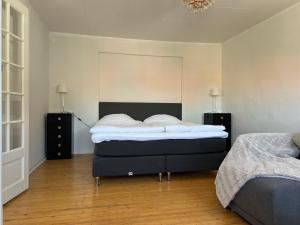 a bedroom with two beds and two night stands at One room apartment the Square in Ystad
