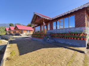 a building with flowers on the side of it at Taray Heem Homestay in Ravangla +5 photos
