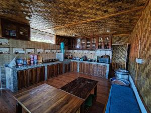 a large kitchen with wooden counters and a wooden table at Taray Heem Homestay in Ravangla