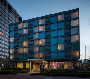 a large glass office building with a lot of windows at Windmill Frankfurt Niederrad in Frankfurt