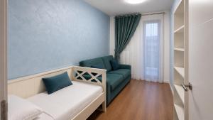 a room with a couch and a chair and a window at Spacious 3-Room Apartment - NEW Building in Bucharest