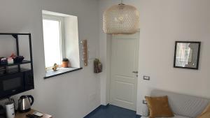 a room with a door and a television and a window at MARIMA' la Casa Vacanze - Holidays Suites in Maratea