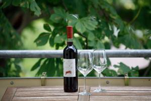a bottle of wine sitting on a table with two wine glasses at Gasthof Krone Hotel & Restaurant in Friedrichshafen