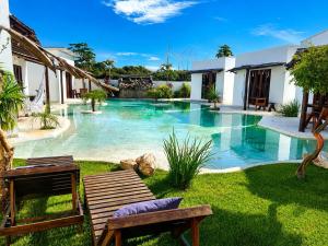 a swimming pool with a bench in a yard at Anacardium in Canoa Quebrada