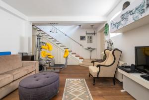 a living room with a couch and chairs and a staircase at Villa San Martein in Rovinj