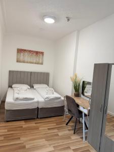 a bedroom with a bed and a desk with a computer at MK Apartments, Chorlton, Manchester Car Park in Manchester