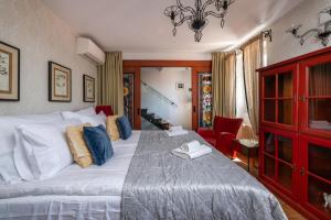 a bedroom with a large bed and a red cabinet at Villa San Martein in Rovinj