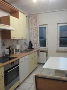 a kitchen with white cabinets and a counter top at FERIENWOHNUNG Marina in Bad Ems