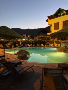a large swimming pool with chairs and umbrellas at Sun Blue Apart Hotel in Marmaris