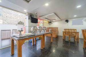 a room with a table with wine glasses on it at Treebo Regalia, Near Medical College & Pattom in Trivandrum