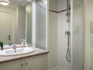 a bathroom with a sink and a shower at Aparthotel Adagio Access Paris Porte De Charenton in Charenton-le-Pont +27 photos