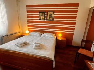 a bedroom with a bed with two towels on it at Apartments Prendivoj in Malinska
