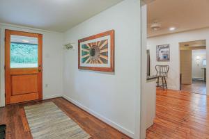 an empty room with a hallway with a door and a table at Bluebird Cottage in Roseland
