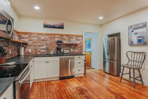 a kitchen with a refrigerator and a chair in it at Bluebird Cottage in Roseland