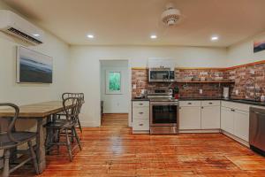 a kitchen with a table and a table and chairs at Bluebird Cottage in Roseland