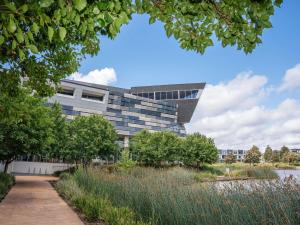 an office building with a garden in front of it at Mercure Melbourne Caroline Springs in Caroline Springs