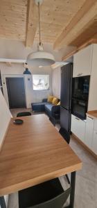 a kitchen and living room with a table and a couch at Casa Petelia in Serra San Bruno