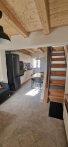 a kitchen and dining room with a staircase in a house at Casa Petelia in Serra San Bruno