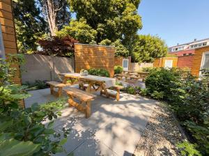 a picnic table and benches in a garden at Spacious Apartment in Tilburg Bed and Coffe in Tilburg