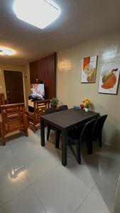 a living room with a table and a dining room at Welcome Home, whole 2 bedroom unit - VCDU Riverview, Mabini Plains in Mabini