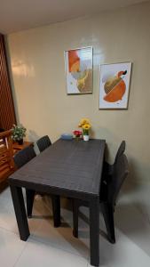 a wooden table and chairs in a room at Welcome Home, whole 2 bedroom unit - VCDU Riverview, Mabini Plains in Mabini +5 photos