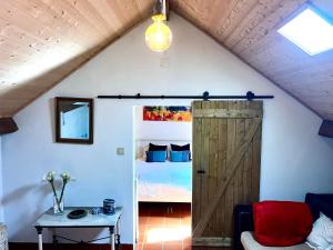 a room with a barn door and a bed at BuganVilla in Santiago do Cacém +16 photos