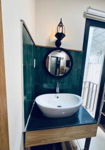 a bathroom with a sink and a mirror at Mint Home in Danang +109 photos
