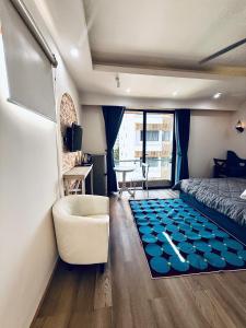 a bedroom with a bed and a couch and a table at Mint Home in Danang