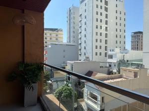 a balcony with a view of a city with buildings at Mint Home in Danang