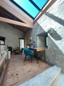 an attic room with a desk and a blue chair at Le Moulin de Tiquetorte in Moulis-en-Médoc +8 photos