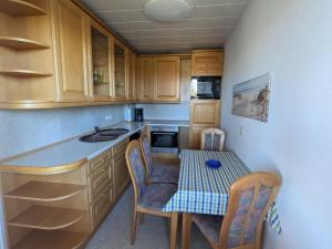 a small kitchen with a table and a sink at Charmante Ferienwohnung Katja in Morbach-Hoxel in Morbach