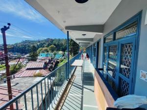 a balcony of a building with a view of a town at Leela's Abode in Bhowāli