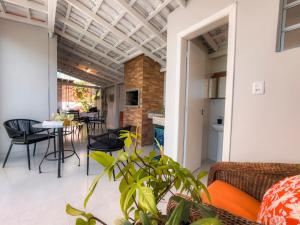 a living room with a couch and a table at Solar Primavera in Palhoça