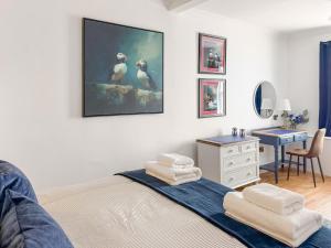 a bedroom with a bed with two towels on it at Nautilus Cottage in Cellardyke +25 photos